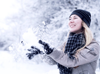 Young happy smiling blond girl outdoor in winter