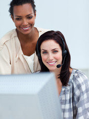 Smiling business partners working at a computer