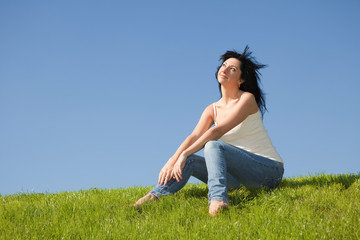 happy young woman rest on the green grass