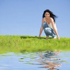 happy young woman rest on the green grass