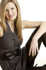 Fototapeta premium portrait of sitting young woman wearing dress