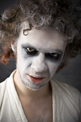 man's face with a grin, disgust, arrogance