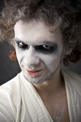 man's face with a grin, disgust, arrogance