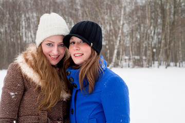 Fototapeta premium sisters posing for the camera in winter