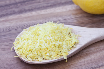 Wooden spoon filled with lemon zest