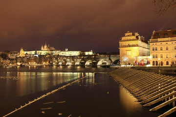 Snowy Prague gothic Castle with Charles Bridge in the Night