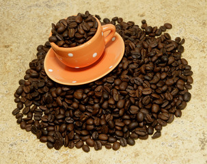 Decorative Coffee Cup on Pile of Coffee Beans