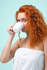 woman in towel with cup