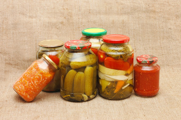 Glass jars with tinned vegetables on a sacking