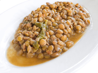 Lentil soup on white dish.
