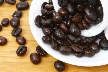 Coffee beans in a white cup