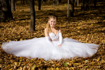 Bride sitting in a park