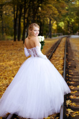 Fototapeta na wymiar Beautiful young bride on a railways