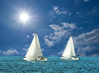 Fototapeta premium two white sail boats in a sea