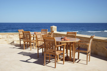 chair and table on sea background