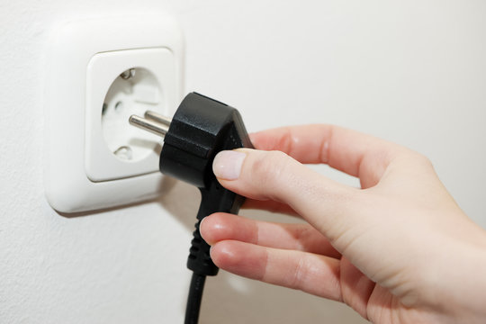 unplugging a plug from electrical socket
