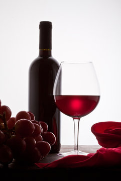 Red Wine And Grapes, White Background.