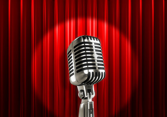 Silver microphone with red curtains