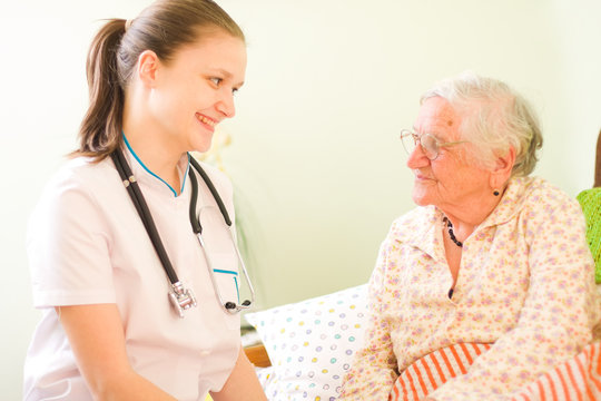 A Young Doctor And Elderly Sick Woman Socialising