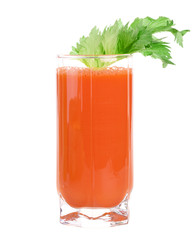 A glass of fresh carrot juice with celery leaves