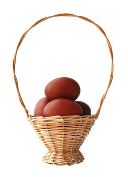 Red Easter eggs in basket on a white background
