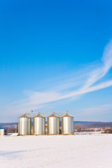 Obraz premium beautiful landscape with silo and snow white acre with blue sky