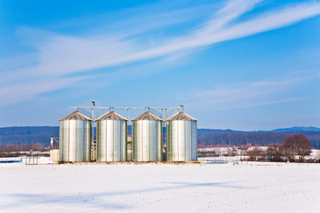 Obraz premium beautiful landscape with silo and snow white acre with blue sky