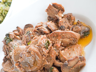 Mushrooms cooked with olive oil, tomato sauce and parsley.