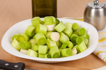 Fresh chopped leeks on a wooden board