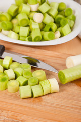 Fresh chopped leeks on a wooden board