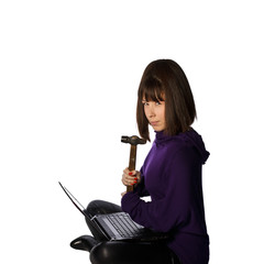 young woman with hammer is breaking her laptop