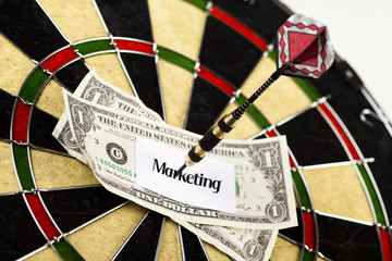 Darts target and dollar in bull's-eye