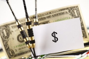 Darts target and dollar in bull's-eye