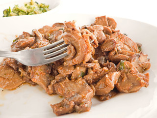 Mushrooms cooked with olive oil and tomato sauce.