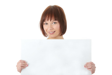 Fototapeta premium A pretty young woman holding a blank sign