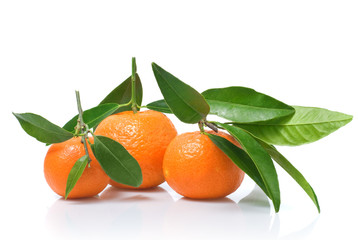 Tangerines with green leaves isolated on white