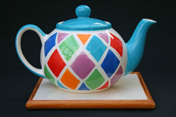 Teapot on ceramic tile stand