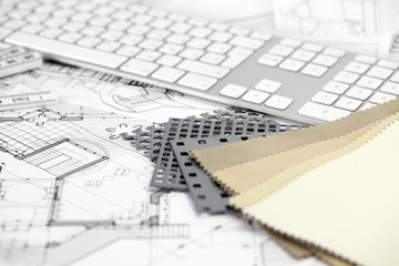computer keyboard, samples of materials and architectural plans