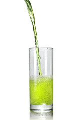 green juice pouring into glass isolated on white