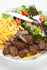 Grilled meat with fried potatoes and vegetables