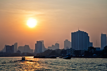 sunrise at river Mae Nam Chao Phraya in Bangkok with skyline