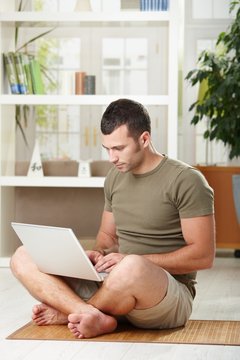 Man using laptop at home