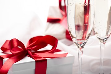 Gift decorated with bow, glass wine