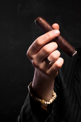 Hand holding cigar