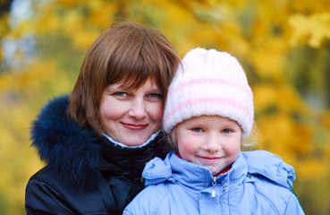 Mother with daughter in autumn city park