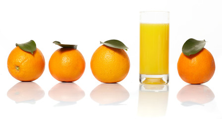 Orange juice and oranges on a white background.