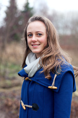 Portrait of a cute teenage woman in a blue coat