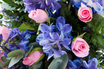 Blue larkspur and pink roses