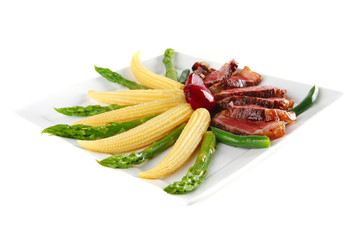 meat served on white with corns
