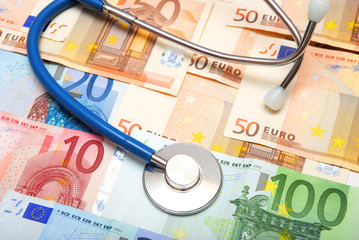 stethoscope over heap of paper money